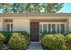 Home's front entrance with well-manicured bushes and a secure screen door, offering curb appeal and enhanced security at 7740 E Heatherbrae Ave # 3, Scottsdale, AZ 85251