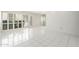 Bright living room with white tile flooring and plantation shutters offers a clean, modern aesthetic at 7740 E Heatherbrae Ave # 3, Scottsdale, AZ 85251