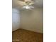 Simple bedroom with carpet flooring, a ceiling fan with lights, and a closet at 8155 W Desert Cove Ave, Peoria, AZ 85345