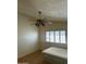 Bright bedroom featuring a bed, ceiling fan, parquet floors, and a window with white shutter blinds at 8155 W Desert Cove Ave, Peoria, AZ 85345
