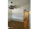 View of a bedroom with wood floors, ceiling fan, vaulted ceilings and doorway to an adjoining room at 8155 W Desert Cove Ave, Peoria, AZ 85345