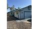 Exterior shot of home and garage, blue paint scheme, xeriscaping and window view at 8155 W Desert Cove Ave, Peoria, AZ 85345
