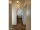 Hallway with terracotta tile, neutral colored walls, arched doorway and view of kitchen at 8155 W Desert Cove Ave, Peoria, AZ 85345