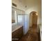 Kitchen with white refrigerator, wood cabinets, tile floor and view into the hallway at 8155 W Desert Cove Ave, Peoria, AZ 85345