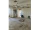 Living room featuring a carpet, ceiling fan, and laundry machines at 8155 W Desert Cove Ave, Peoria, AZ 85345