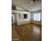 Spacious living room with wood floors and plantation shutters letting in natural light at 8155 W Desert Cove Ave, Peoria, AZ 85345
