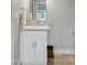 Chic powder room with a granite countertop, white vanity, and modern fixtures at 8361 E San Rafael Dr, Scottsdale, AZ 85258