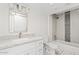 Well-lit bathroom with granite counters, tiled shower-tub combo, and stylish fixtures at 8361 E San Rafael Dr, Scottsdale, AZ 85258