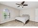 Bedroom features an arched window and comfortable furnishings at 8361 E San Rafael Dr, Scottsdale, AZ 85258