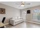 Comfortable bedroom featuring a white sofa, arched windows, and wood-look flooring, creating a cozy retreat at 8361 E San Rafael Dr, Scottsdale, AZ 85258