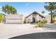 Inviting exterior with desert landscaping, arched entryway, three-car garage, and terracotta roof at 8361 E San Rafael Dr, Scottsdale, AZ 85258