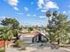 Charming home with a well-manicured front yard, mature trees, and a circular driveway offering curb appeal at 8361 E San Rafael Dr, Scottsdale, AZ 85258