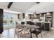 Open-concept kitchen with updated appliances next to breakfast area and backyard access at 8361 E San Rafael Dr, Scottsdale, AZ 85258