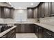 Updated kitchen with gray cabinets, subway tile backsplash, and granite countertops at 8361 E San Rafael Dr, Scottsdale, AZ 85258