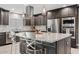 Modern kitchen featuring a stainless steel range hood and island with seating at 8361 E San Rafael Dr, Scottsdale, AZ 85258