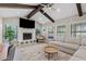 Bright living room featuring vaulted ceilings and wooden beams with a fireplace at 8361 E San Rafael Dr, Scottsdale, AZ 85258