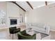 Cozy living room with fireplace and large windows at 8361 E San Rafael Dr, Scottsdale, AZ 85258