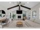 Bright living room with vaulted ceiling, wooden beams, fireplace, and expansive windows at 8361 E San Rafael Dr, Scottsdale, AZ 85258