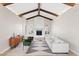 Bright living room features high ceilings, wooden beams and a cozy fireplace at 8361 E San Rafael Dr, Scottsdale, AZ 85258