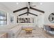Open living room and kitchen area featuring vaulted ceilings and exposed wooden beams at 8361 E San Rafael Dr, Scottsdale, AZ 85258
