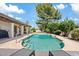 Inviting pool area with blue water, lush landscaping, and covered patio, perfect for outdoor relaxation and entertaining at 8361 E San Rafael Dr, Scottsdale, AZ 85258