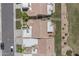Overhead view of a community of homes with tile roofs, green lawns and mature trees at 8431 W Utopia Rd, Peoria, AZ 85382
