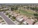 Overhead view of a community of homes with tile roofs, green lawns and mature trees at 8431 W Utopia Rd, Peoria, AZ 85382