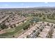 Expansive view of a community of homes with tile roofs, green lawns and mature trees at 8431 W Utopia Rd, Peoria, AZ 85382