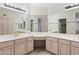 Bathroom with double sinks, large mirrors, and a makeup vanity area at 8431 W Utopia Rd, Peoria, AZ 85382