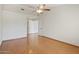 Large bedroom featuring wood floors, a ceiling fan, and ample natural light at 8431 W Utopia Rd, Peoria, AZ 85382
