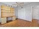 A bedroom with laminate floors, built in shelves and a closet with sliding doors at 8431 W Utopia Rd, Peoria, AZ 85382