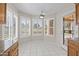 Bright breakfast nook featuring tiled floor, ceiling fan, and large windows with backyard view at 8431 W Utopia Rd, Peoria, AZ 85382