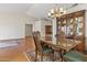 Traditional dining room featuring hardwood floors, a chandelier, and large china cabinet at 8431 W Utopia Rd, Peoria, AZ 85382
