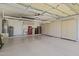 Spacious garage with epoxy flooring and cabinets offers ample storage solutions at 8431 W Utopia Rd, Peoria, AZ 85382