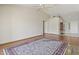 Spacious living room with wood floors and a large rug; with lots of light at 8431 W Utopia Rd, Peoria, AZ 85382
