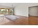 Bright living room with wood floors, ceiling fan and sliding glass door to the backyard at 8431 W Utopia Rd, Peoria, AZ 85382