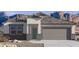 Charming single-story home with neutral stucco, desert landscaping, and a two-car garage nestled against a mountain backdrop at 8543 W Gehrig Way, Florence, AZ 85132