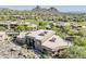 Scenic aerial view of a luxury home in a golf community with mountain views at 10222 E Southwind Ln # 1018, Scottsdale, AZ 85262