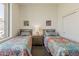 Bright bedroom featuring twin beds with colorful bedding and a sliding door closet at 10222 E Southwind Ln # 1018, Scottsdale, AZ 85262