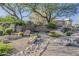 Beautiful stone entrance to The Golf Villas at Troon North with lush landscaping and desert accents at 10222 E Southwind Ln # 1018, Scottsdale, AZ 85262