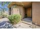 Inviting front entrance with a wood door, desert landscaping, and a serene atmosphere at 10222 E Southwind Ln # 1018, Scottsdale, AZ 85262