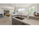 Modern kitchen area with a stainless steel sink, quartz countertops, and views at 10222 E Southwind Ln # 1018, Scottsdale, AZ 85262