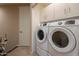 Modern laundry room featuring front-load washer and dryer and built-in storage cabinets at 10222 E Southwind Ln # 1018, Scottsdale, AZ 85262