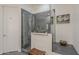 Modern shower enclosed in clear glass, featuring grey tiling, a built-in bench, and stylish decor at 10222 E Southwind Ln # 1018, Scottsdale, AZ 85262