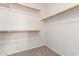 Walk-in closet showing multiple racks for storage with neutral carpet and white walls at 10845 W Manzanita Dr, Peoria, AZ 85345