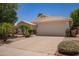 Beige single-story home with a two car garage and desert landscaping at 10845 W Manzanita Dr, Peoria, AZ 85345