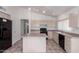 Bright kitchen features tile flooring, an island, and a black gas range at 10845 W Manzanita Dr, Peoria, AZ 85345