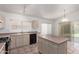 Spacious kitchen with tile flooring and an island with built-in cabinets at 10845 W Manzanita Dr, Peoria, AZ 85345