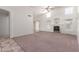 Spacious living room featuring high ceilings, neutral carpet, fireplace and lots of natural light at 10845 W Manzanita Dr, Peoria, AZ 85345