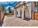 Backyard brick-paved patio with covered porch, small lawn, and block wall fencing in a private setting at 1090 S Bogle Ct, Chandler, AZ 85286